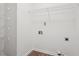 A well lit laundry room featuring hardwood floors and wired shelving for storage at 4005 Greentree Ct, Douglasville, GA 30135