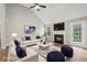 Bright living room with a fireplace, vaulted ceiling, wood floors, and plush seating area at 4005 Greentree Ct, Douglasville, GA 30135
