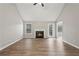 Bright living room featuring vaulted ceilings, wood floors, and a fireplace at 4005 Greentree Ct, Douglasville, GA 30135
