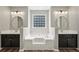 Main bathroom with dual vanities, a soaking tub and an obscured glass window at 4005 Greentree Ct, Douglasville, GA 30135