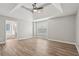 Spacious main bedroom featuring large window, hardwood floors and ceiling fan at 4005 Greentree Ct, Douglasville, GA 30135