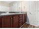 Bathroom with double sinks, dark countertop, and wooden drawers/cabinetry at 222 Ben Ln, Fairburn, GA 30213