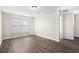 Bedroom with hardwood flooring and a bright window with horizontal blinds at 222 Ben Ln, Fairburn, GA 30213