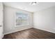 Bedroom with bright window, neutral paint and hardwood flooring at 222 Ben Ln, Fairburn, GA 30213