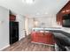 Modern kitchen with black appliances, wood cabinets, and hardwood floors at 222 Ben Ln, Fairburn, GA 30213