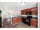 Well-equipped kitchen featuring black appliances and classic wood cabinetry at 222 Ben Ln, Fairburn, GA 30213