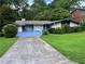 Charming single-story home with blue accents, a unique driveway, a well-maintained front yard at 2323 Valleyside Dr, Decatur, GA 30032