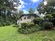 Exterior view of home with brick facade, lush greenery, and mature trees at 2323 Valleyside Dr, Decatur, GA 30032
