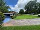 Charming home with a lush green lawn, mature trees, and a blue garage at 2323 Valleyside Dr, Decatur, GA 30032