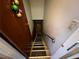 Stairway leading to a lower level, with a door and a light switch on the wall at 2323 Valleyside Dr, Decatur, GA 30032