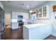 Bright kitchen features stainless steel appliances, white cabinets, and beautiful hardwood floors at 360 Kelly Se St, Atlanta, GA 30312