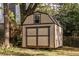 Backyard shed with a single pane window and double doors, in a fenced yard at 360 Kelly Se St, Atlanta, GA 30312
