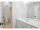 Bright bathroom featuring a white vanity with a large mirror and a toilet next to a shower at 5513 Lavender Farms Rd, Powder Springs, GA 30127