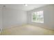 Cozy bedroom features natural light, carpet, and fresh paint at 5513 Lavender Farms Rd, Powder Springs, GA 30127