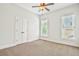 Bedroom features fresh paint, carpet, and two windows at 5513 Lavender Farms Rd, Powder Springs, GA 30127