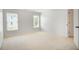 Bedroom features neutral carpet, two windows, and closet; the perfect space to rest and recharge for the next day at 5513 Lavender Farms Rd, Powder Springs, GA 30127