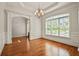 Elegant dining room featuring hardwood floors, large windows, and classic chandelier at 5513 Lavender Farms Rd, Powder Springs, GA 30127
