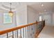 Hallway features detailed railing, a window, and an open layout at 5513 Lavender Farms Rd, Powder Springs, GA 30127