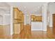 Bright kitchen adjacent to living area with light wood cabinetry and stainless appliances at 5513 Lavender Farms Rd, Powder Springs, GA 30127
