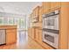 Kitchen area with stainless steel appliances and light wood cabinetry at 5513 Lavender Farms Rd, Powder Springs, GA 30127