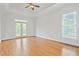 Bright main bedroom offering hardwood floors and a door that leads to a balcony at 5513 Lavender Farms Rd, Powder Springs, GA 30127