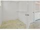 A walk-in closet with custom shelving and ceramic tile flooring at 5513 Lavender Farms Rd, Powder Springs, GA 30127
