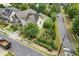 Aerial view shows a home with well-manicured landscaping, complemented by a picket fence and mature trees at 1184 Medlin Se St, Smyrna, GA 30080