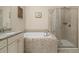 Elegant bathroom featuring a soaking tub and separate glass-enclosed shower at 1184 Medlin Se St, Smyrna, GA 30080