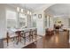 Formal dining room with hardwood floors, modern lighting fixture, wainscotting, and a table set for elegant dining at 1184 Medlin Se St, Smyrna, GA 30080
