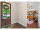 Inviting entryway featuring a view into a cozy study with built-in shelves and an Eames chair at 1184 Medlin Se St, Smyrna, GA 30080