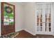 Warm entryway with a decorative wooden door and access to a study through elegant glass French doors at 1184 Medlin Se St, Smyrna, GA 30080