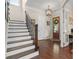 Inviting foyer featuring hardwood floors, staircase with rod iron railing, and a beautiful front door with glass panels at 1184 Medlin Se St, Smyrna, GA 30080