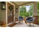 Charming front porch with cozy seating and a beautifully decorated wooden door, creating a welcoming ambiance at 1184 Medlin Se St, Smyrna, GA 30080