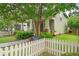 Charming home featuring a lovely front yard with a picket fence and colorful flowers at 1184 Medlin Se St, Smyrna, GA 30080