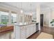 Kitchen island featuring granite countertops, pendant lighting, stainless steel dishwasher and views to the outdoors through multiple windows at 1184 Medlin Se St, Smyrna, GA 30080