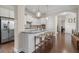 Open kitchen with a center island, granite countertops, stainless steel appliances, and an open view to the living spaces at 1184 Medlin Se St, Smyrna, GA 30080