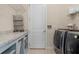 Functional laundry room features modern washer/dryer, ample countertop space, and convenient storage solutions at 1184 Medlin Se St, Smyrna, GA 30080