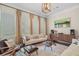 Well-appointed living room featuring modern furniture, large windows, decorative lighting, and dark hardwood flooring at 1184 Medlin Se St, Smyrna, GA 30080