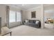 Comfortable living room includes a sofa, side table, and large windows for plenty of natural light at 1184 Medlin Se St, Smyrna, GA 30080