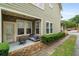 Cozy covered patio with seating, a fire pit, and manicured landscaping along the side of the house at 1184 Medlin Se St, Smyrna, GA 30080