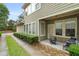 Cozy covered patio with seating, a fire pit, and manicured landscaping along the side of the house at 1184 Medlin Se St, Smyrna, GA 30080