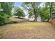 Expansive backyard showcasing the home's exterior, mature trees, and ample space for outdoor activities and relaxation at 1366 Allegheny Sw St, Atlanta, GA 30310