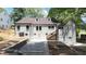 Backyard of home, showcasing fresh paint, updated stone foundation, and stairway to backyard, highlighting the home's charm at 1366 Allegheny Sw St, Atlanta, GA 30310