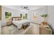 Well-lit bedroom with a large bed, multiple windows, and a decorative bench at 1366 Allegheny Sw St, Atlanta, GA 30310