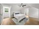 Inviting bedroom with sloped ceilings, a ceiling fan, and wood-look flooring, creating a cozy and stylish retreat at 1366 Allegheny Sw St, Atlanta, GA 30310