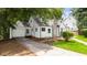 Charming home exterior with attached garage and driveway surrounded by mature trees at 1366 Allegheny Sw St, Atlanta, GA 30310