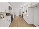 Modern kitchen with white cabinetry, stainless steel appliances, and hardwood floors at 1366 Allegheny Sw St, Atlanta, GA 30310