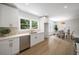 Bright kitchen featuring white cabinets, stainless steel appliances, and adjacent dining area with modern lighting at 1366 Allegheny Sw St, Atlanta, GA 30310