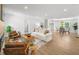 Spacious living room with hardwood floors, neutral decor, dining area and recessed lighting at 1366 Allegheny Sw St, Atlanta, GA 30310