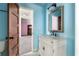 Bright bathroom with blue walls, a decorative vanity, and a view into the bedroom at 178 Mayson Ne Ave, Atlanta, GA 30307